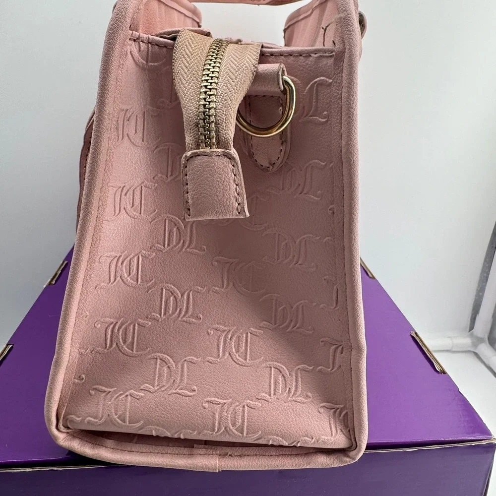 Y2K Juicy Couture satchel in pink, features an all-over embossed 